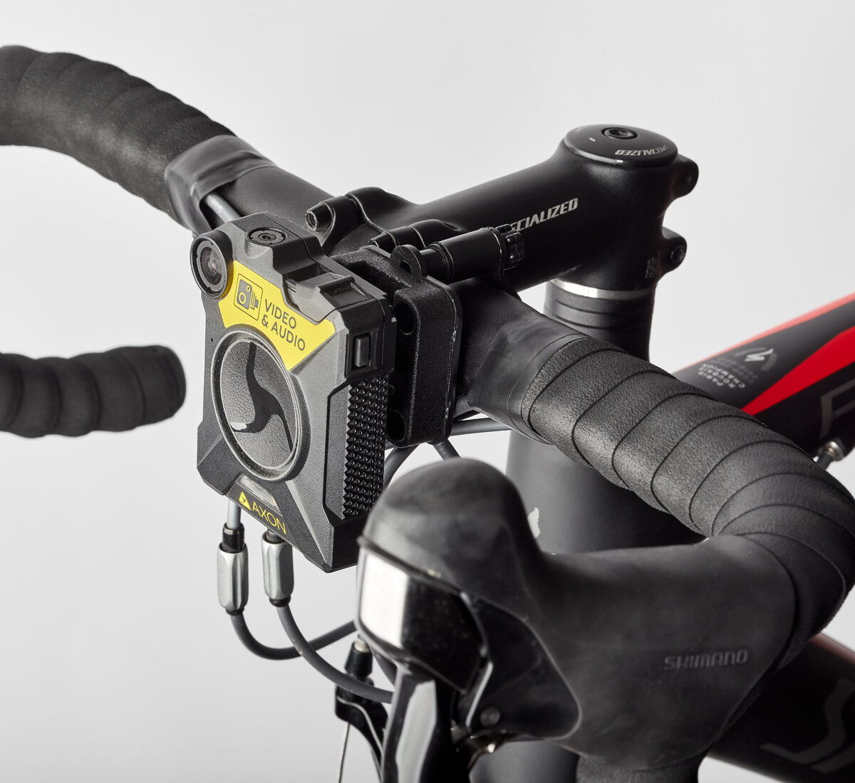 Axon camera attached to a bike handle bars via a Klick Fast Camera Bike Mount.