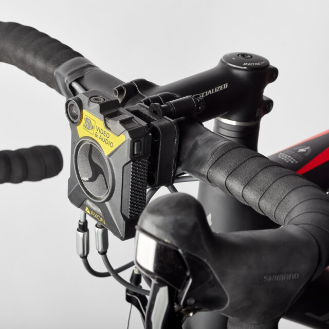 Axon camera attached to a bike handle bars via a Klick Fast Camera Bike Mount.