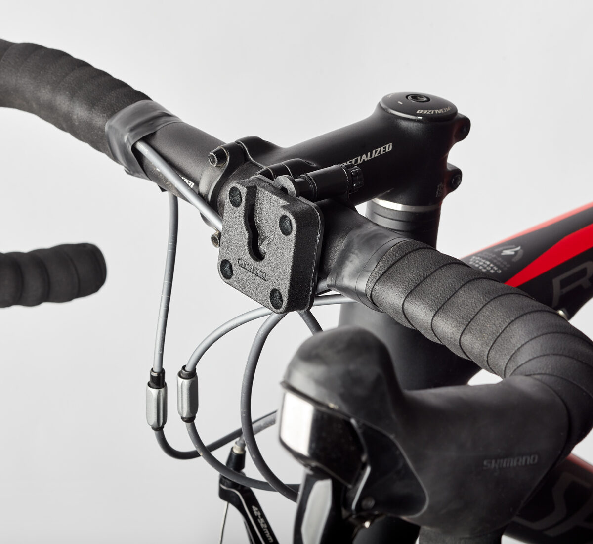 Klick Fast Handlebar Mount for Cameras or Lights attached to the centre of a bike handlebars.